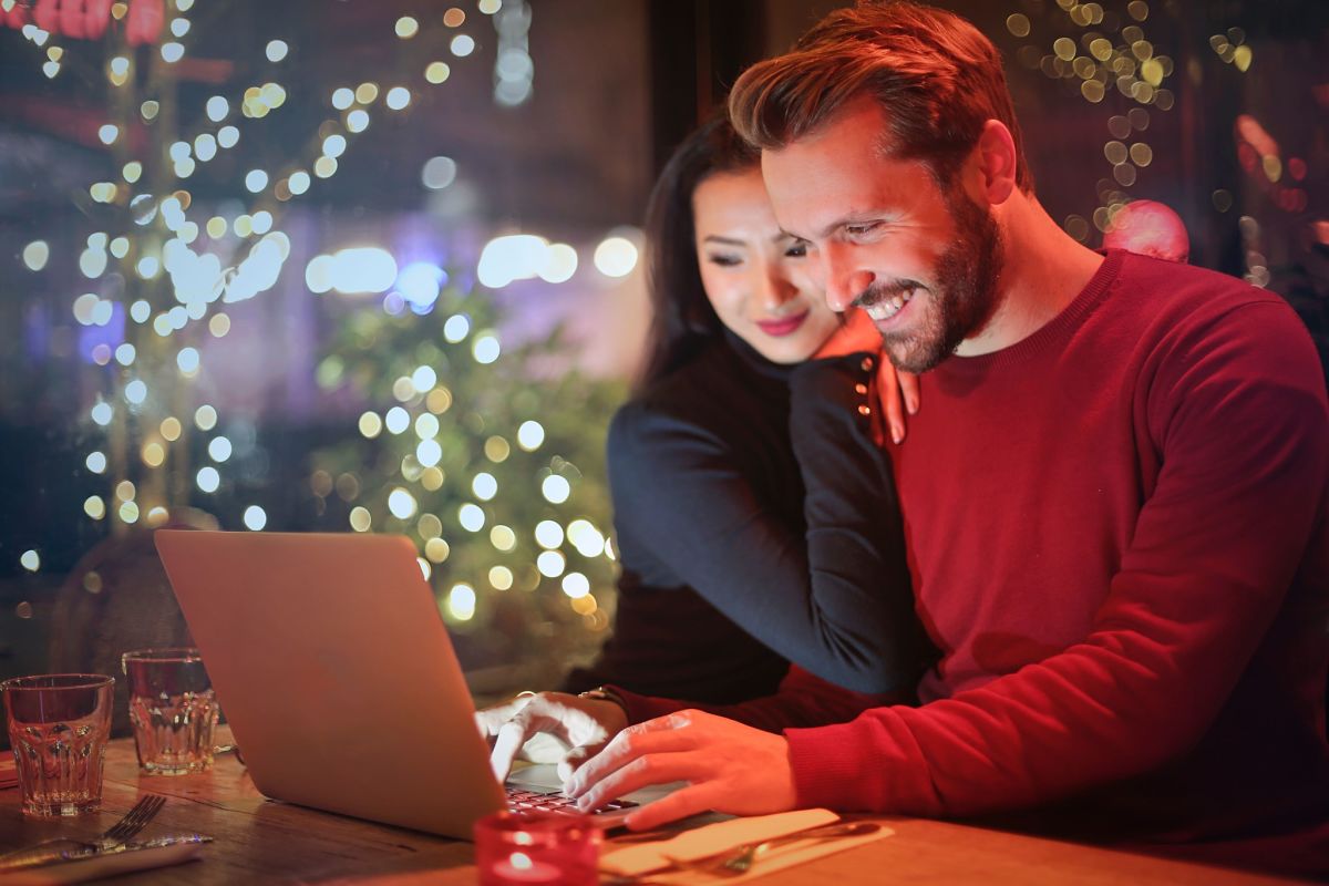 men and women in front of laptop